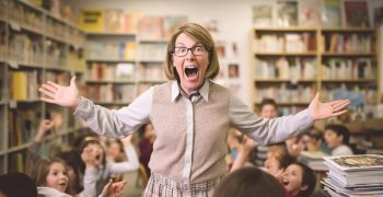 teacher-with-sign-that-says-school-reading_664644-3560